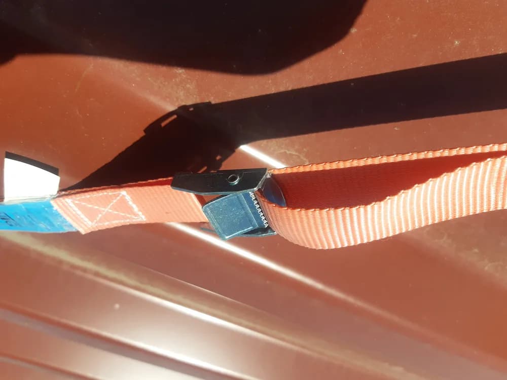 A cargo tie-down strap with a cam buckle.